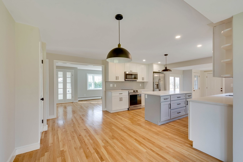 34 Irving Drive Walpole, MA 02081 - Photo 10 of 42 a kitchen with stainless steel appliances granite countertop a sink refrigerator and cabinets