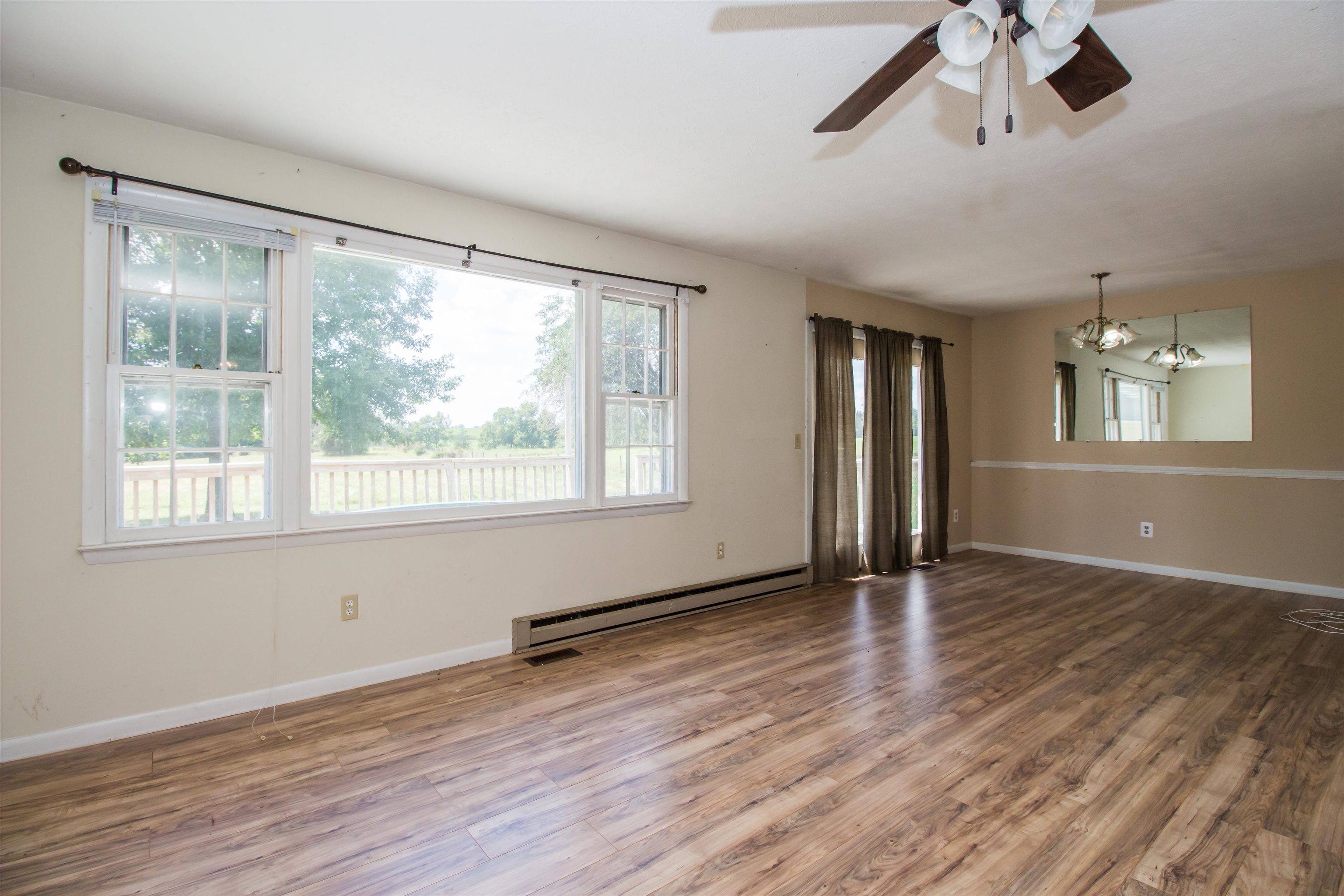 322 Endless Caverns Road Timberville, VA 22853 - Photo 5 of 43 a view of an empty room with wooden floor and a window