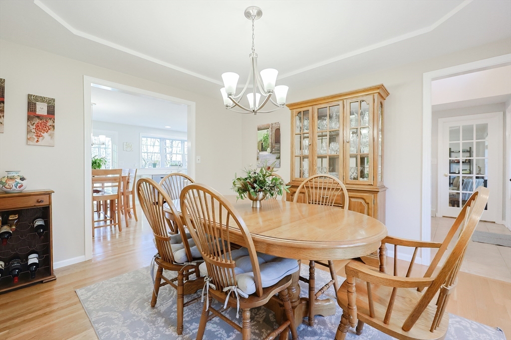52 Quail Creek Road North Attleboro, MA 02760 - Photo 13 of 42 a view of a dining room with furniture a chandelier and wooden floor