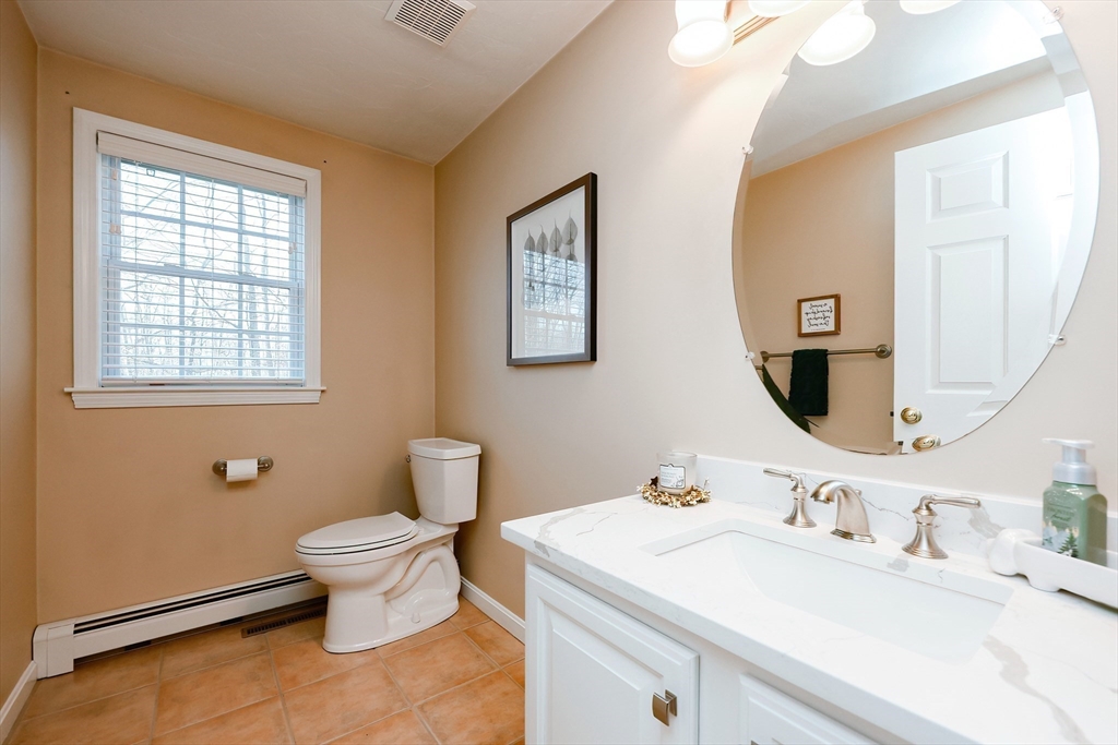 52 Quail Creek Road North Attleboro, MA 02760 - Photo 17 of 42 a bathroom with a toilet sink and mirror