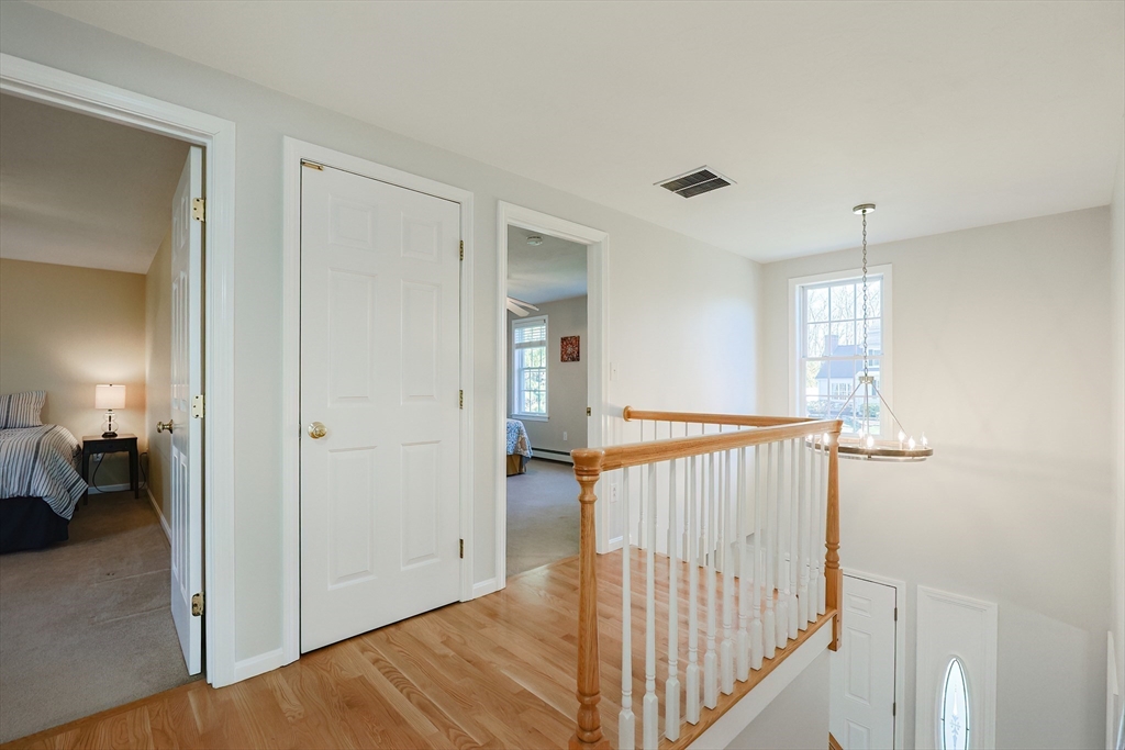 52 Quail Creek Road North Attleboro, MA 02760 - Photo 19 of 42 a view of a hallway with closet and stairs