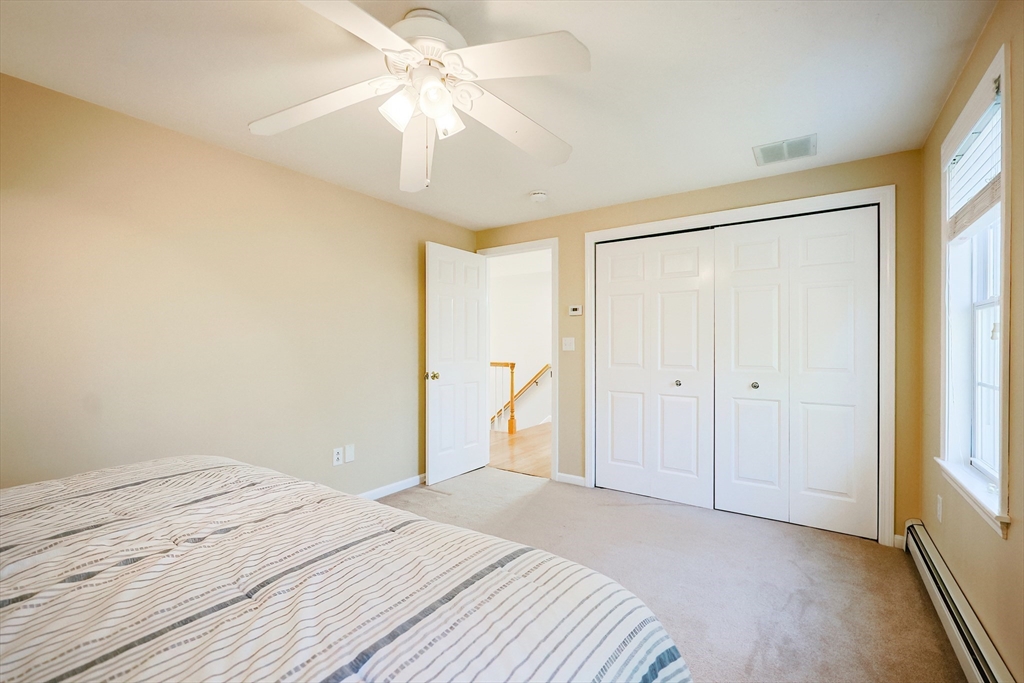 52 Quail Creek Road North Attleboro, MA 02760 - Photo 23 of 42 a bedroom with a large bed and a chandelier