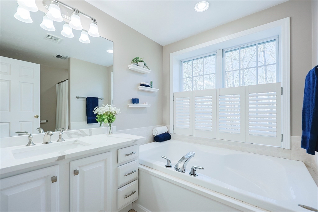 52 Quail Creek Road North Attleboro, MA 02760 - Photo 28 of 42 a bathroom with a tub a sink and mirror