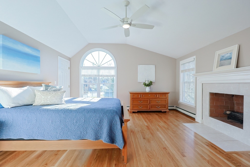 52 Quail Creek Road North Attleboro, MA 02760 - Photo 29 of 42 a bedroom with a bed and a fireplace