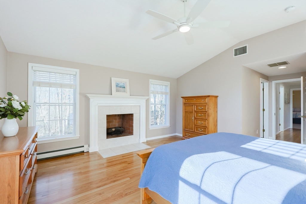 52 Quail Creek Road North Attleboro, MA 02760 - Photo 32 of 42 a bedroom with a bed and a fireplace