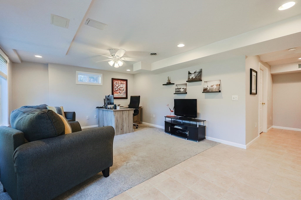 52 Quail Creek Road North Attleboro, MA 02760 - Photo 36 of 42 a living room with furniture and a flat screen tv