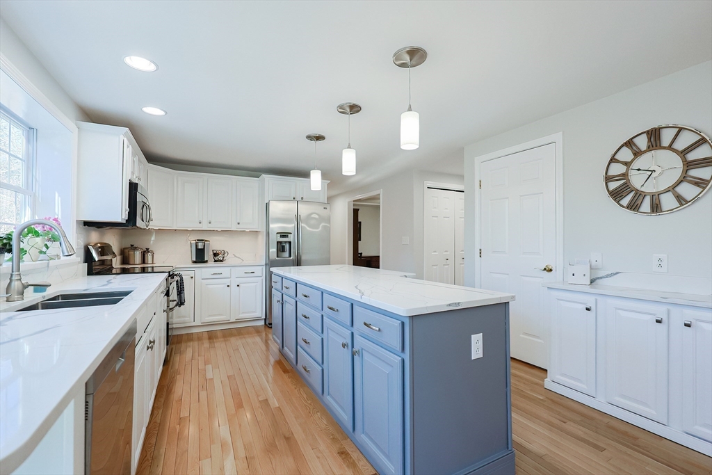 52 Quail Creek Road North Attleboro, MA 02760 - Photo 8 of 42 a kitchen with a stove a sink and a refrigerator
