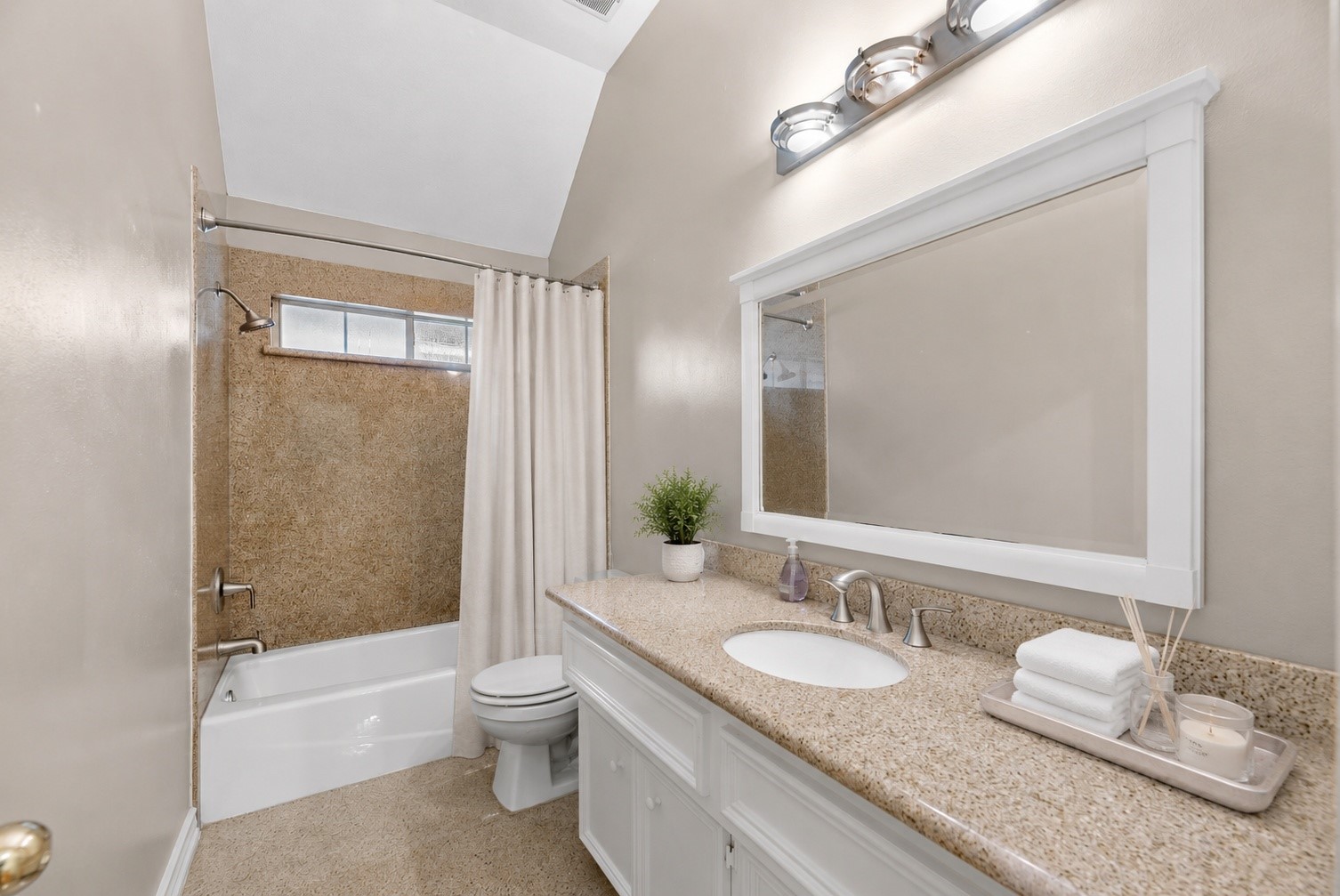5724 Shady Hollow Court Rosharon, TX 77583 - Photo 16 of 27 Beautifully updated bathroom featuring durable granite finishes throughout, from the vanity countertops to the flooring and shower surround. The seller installed a cast-iron tub for long-lasting quality and durability, paired with updated fixtures for a clean, refreshed look. The vanity offers generous counter space, a framed mirror, and bright lighting, while the shower area includes a neutral curtain and tasteful spa-inspired touches that help showcase the space’s potential for the next homeowner.