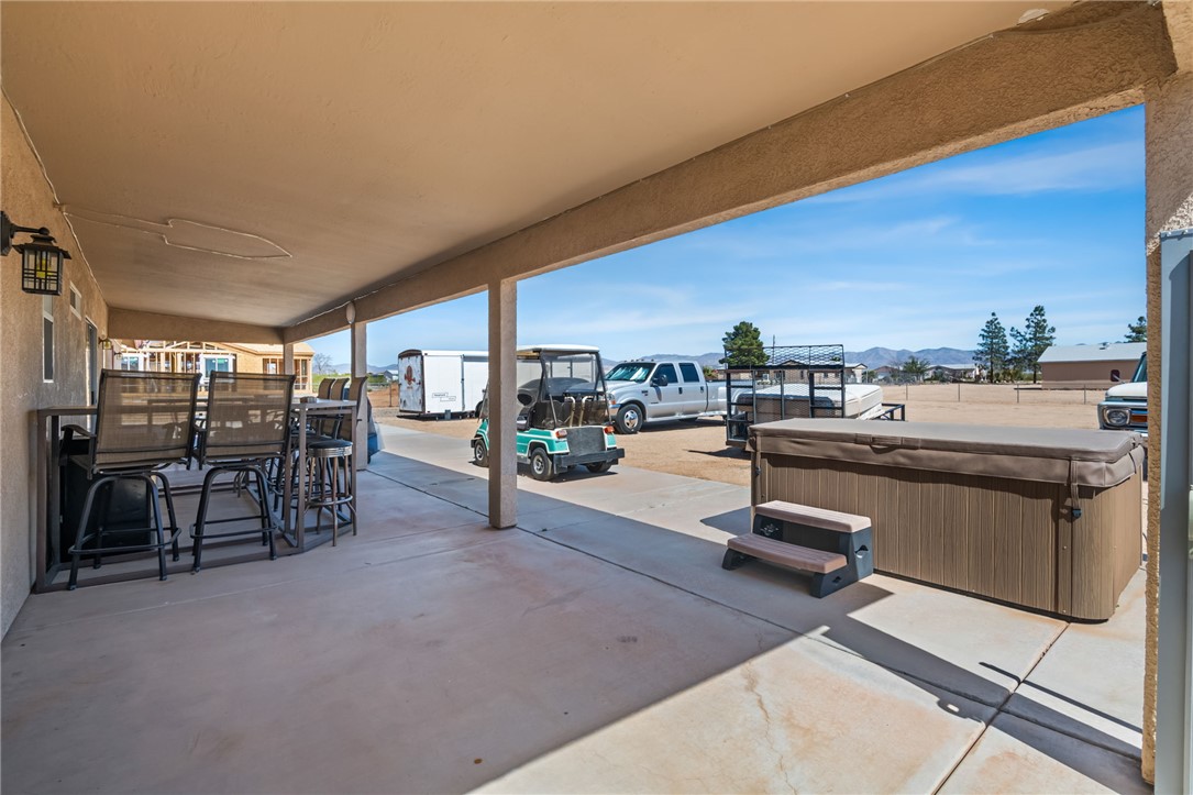 3668 North Neptune Road Golden Valley, AZ 86413 - Photo 12 of 38 Spacious covered patio with concrete flooring, providing an ideal setting for outdoor recreation