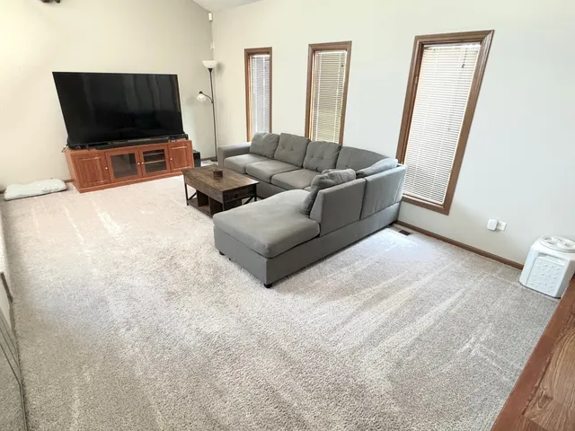 a living room with a couch and a dining table