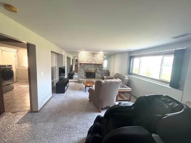 a kitchen with stainless steel appliances wooden floor sink and wooden floor