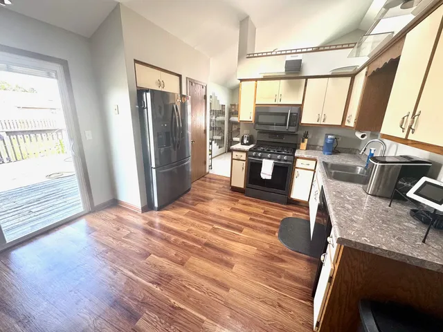 a view of a dining room with furniture and chandelier