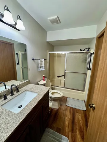 a bedroom with a bed and a large mirror on the dresser