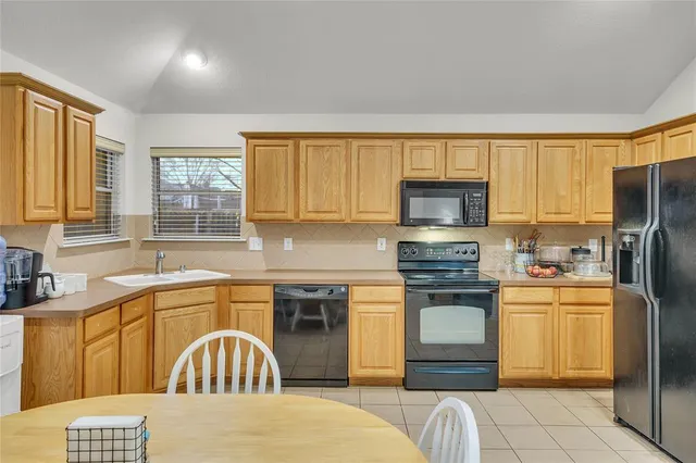 a kitchen with a sink a stove and refrigerator