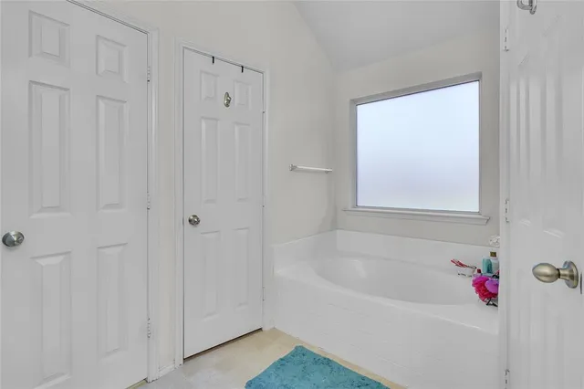 a white bath tub sitting next to a window