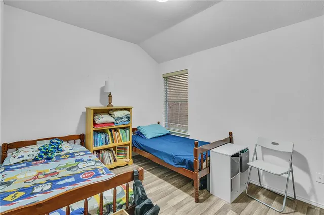a bedroom with furniture and a wooden floor