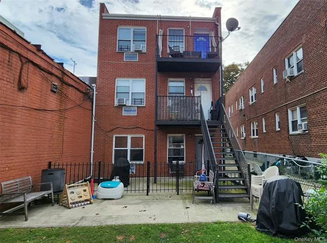 a view of a brick house with many windows and a table