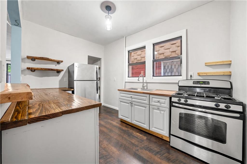 2806 Cortelyou Road Brooklyn, NY 11226 - Photo 4 of 13 a kitchen with a stove and a sink