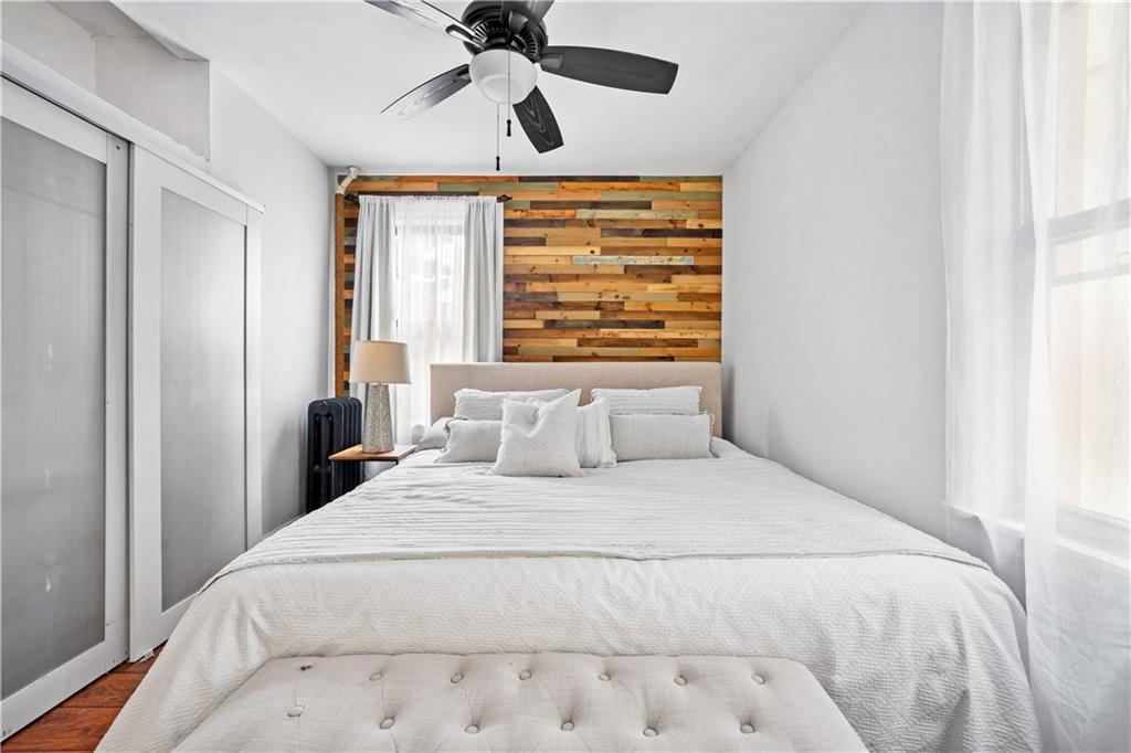 2806 Cortelyou Road Brooklyn, NY 11226 - Photo 8 of 13 a bedroom with a large bed and a window