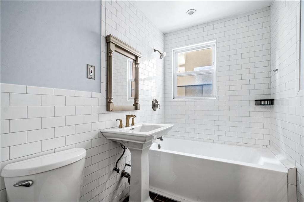 2806 Cortelyou Road Brooklyn, NY 11226 - Photo 9 of 13 a bathroom with a sink a toilet and shower