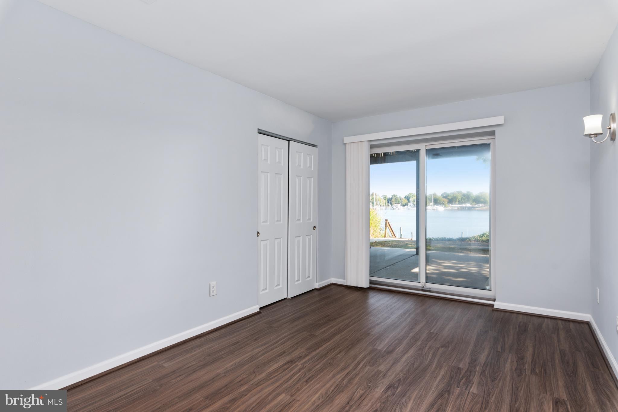 211 St Marys Road Baltimore, MD 21221 - Photo 45 of 50 an empty room with wooden floor and windows