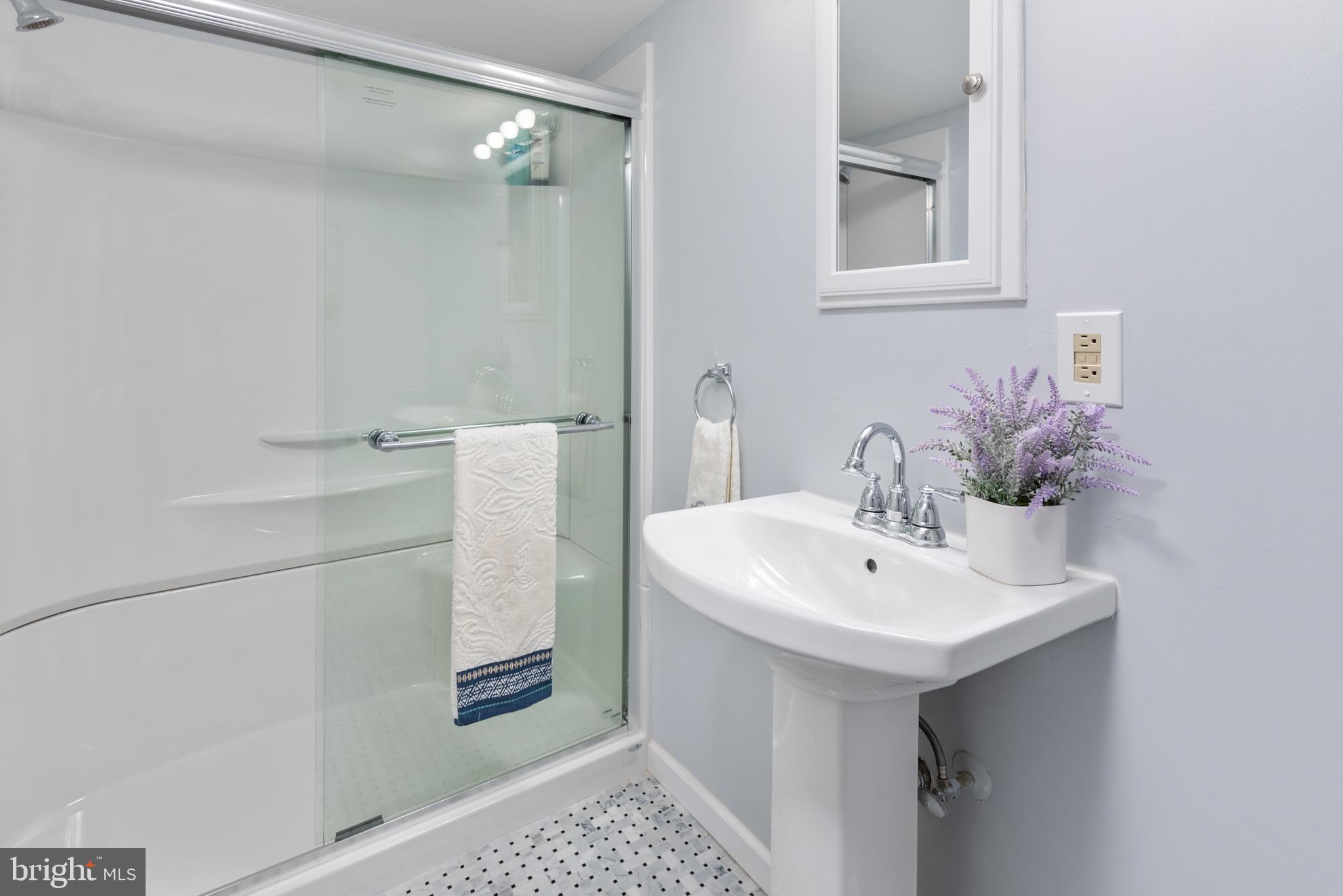 211 St Marys Road Baltimore, MD 21221 - Photo 47 of 50 a bathroom with a sink a mirror and a shower