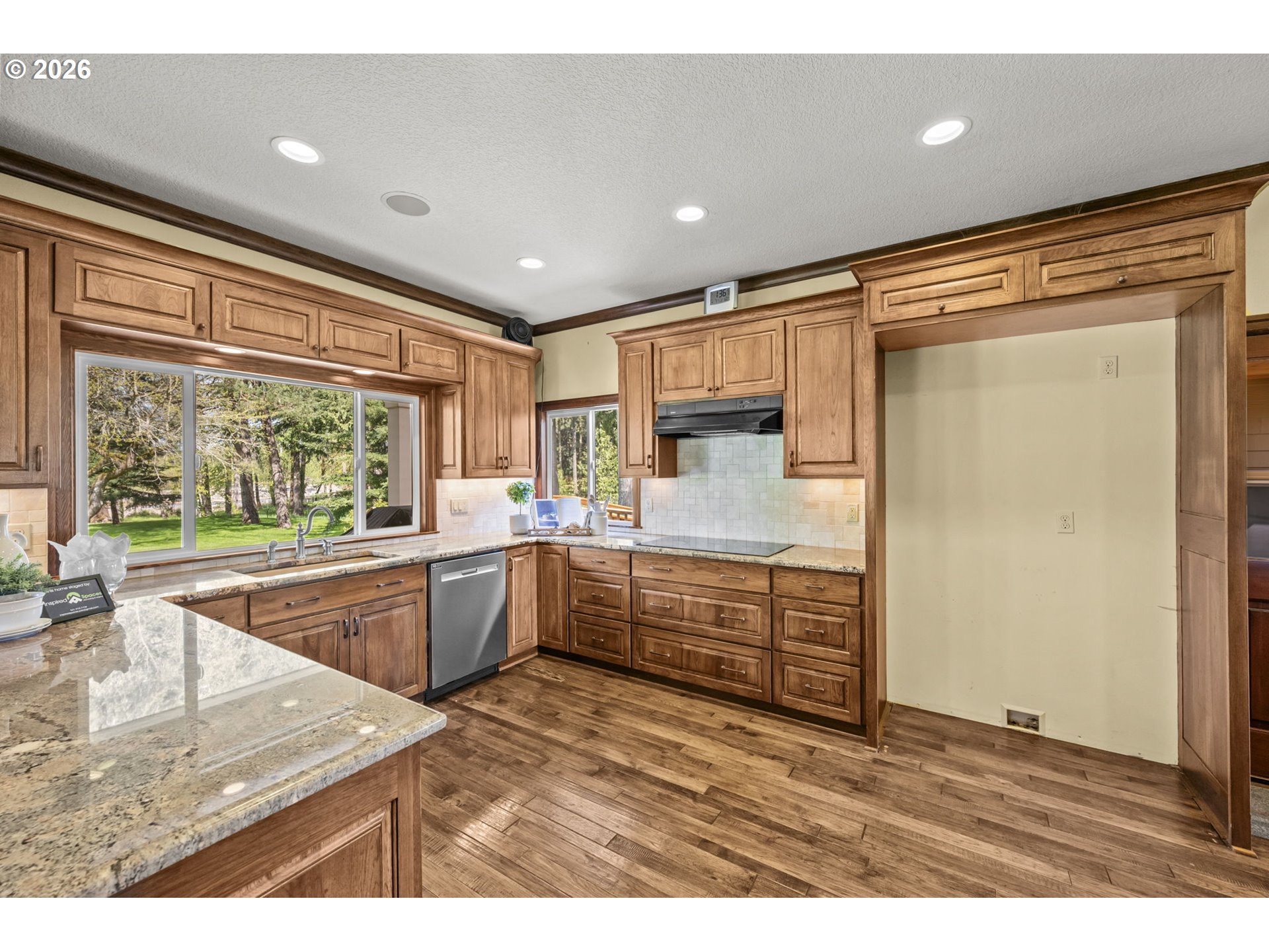 8121 South Vale Garden Road Canby, OR 97013 - Photo 11 of 48 a kitchen with kitchen island a large counter top space appliances and a sink