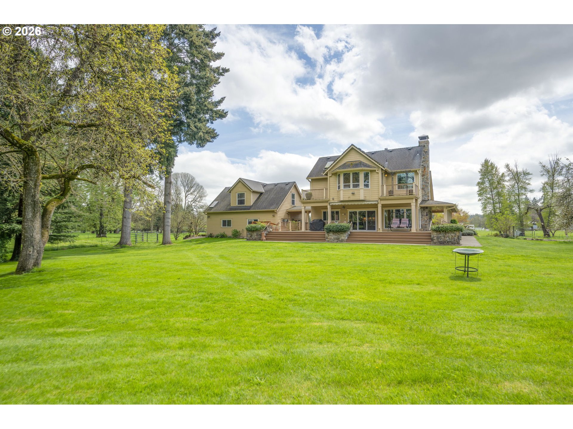 8121 South Vale Garden Road Canby, OR 97013 - Photo 39 of 48 a view of a big house with a big yard and large trees