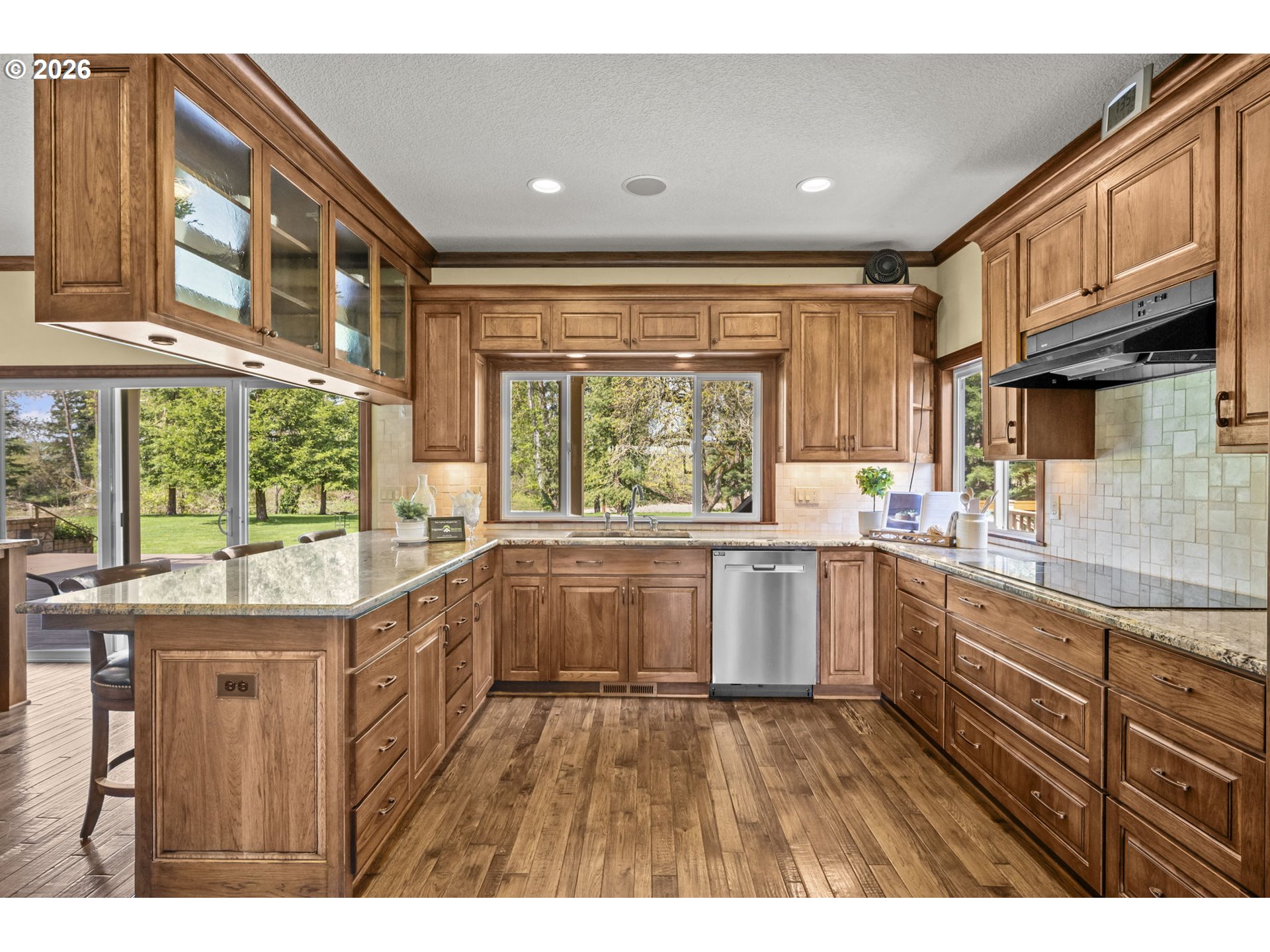 8121 South Vale Garden Road Canby, OR 97013 - Photo 10 of 48 a kitchen that has a lot of cabinets and wooden floor