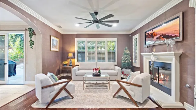 a living room with furniture a fireplace and a large window