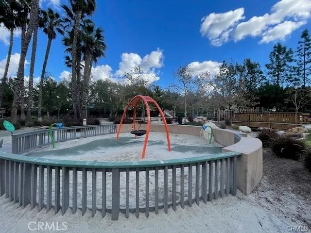 a view of a house with a big yard potted plants and large tree