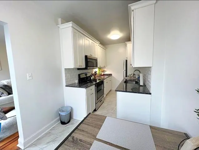 a kitchen with a sink and wooden cabinets