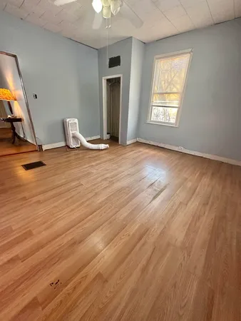a view of a room with wooden floor and windows