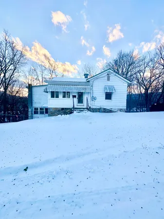a view of house with a yard