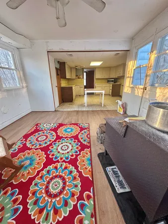 a living room with a couch and piano table