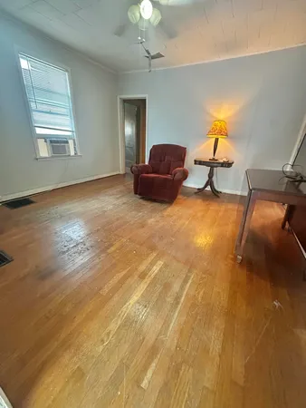 a view of a livingroom with furniture and wooden floor