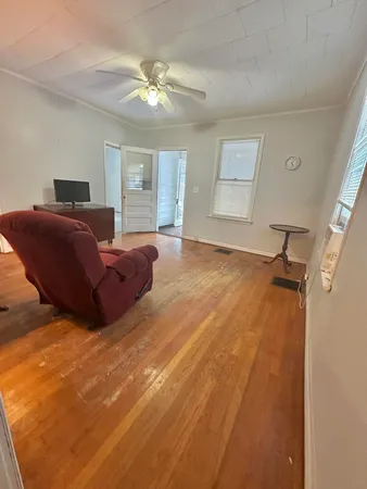 a spacious bedroom with a bed and a chandelier