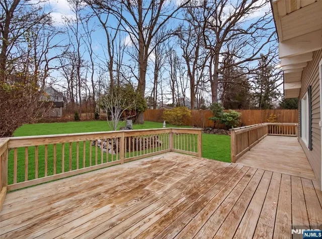 a view of a deck with mountain view and wooden floor