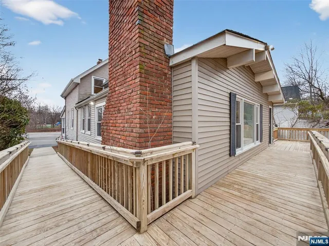 a view of a house with wooden deck