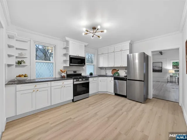 a kitchen with a refrigerator stove and microwave