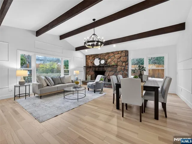 a living room with furniture a fireplace and a dining table