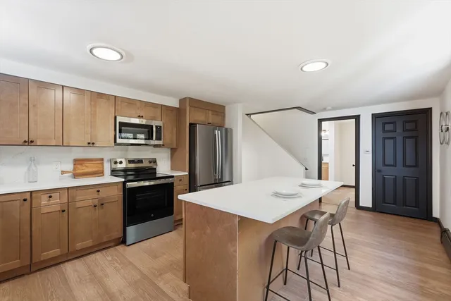 a kitchen with a stove a sink and a refrigerator