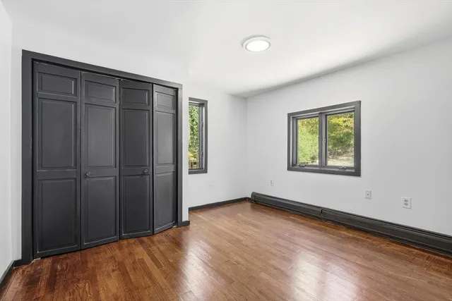 a view of a kitchen with wooden floor and electronic appliances