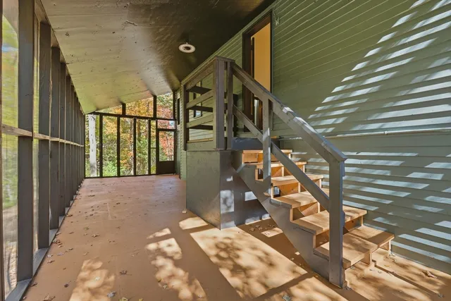 a backyard of a house with table and chairs
