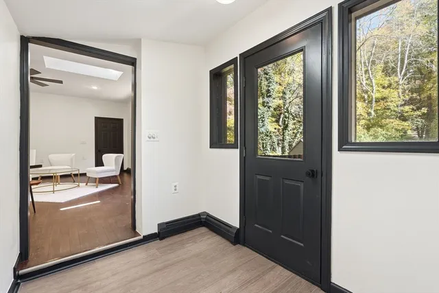a view of a hallway that has a bench in it