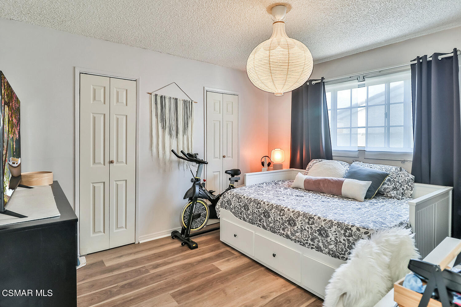 1776 Cochran Street Simi Valley, CA 93065 - Photo 20 of 43 a bedroom with a large bed and a chandelier