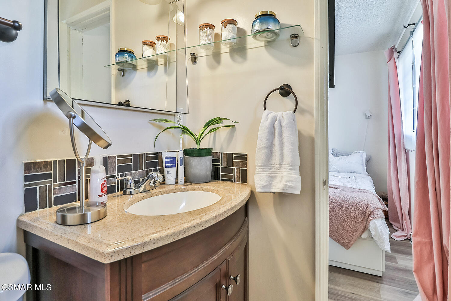 1776 Cochran Street Simi Valley, CA 93065 - Photo 28 of 43 a bathroom with a granite countertop sink and a mirror