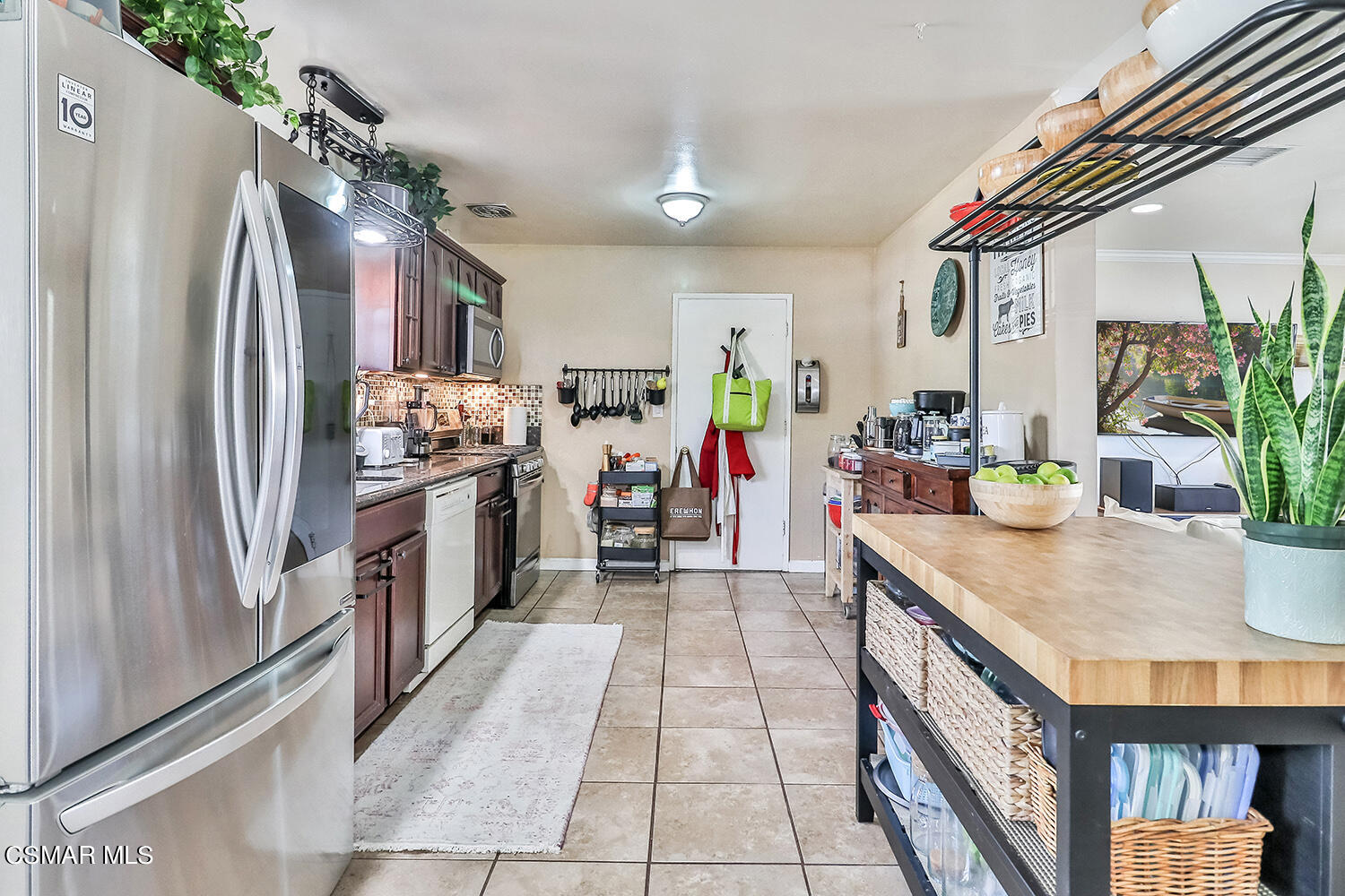 1776 Cochran Street Simi Valley, CA 93065 - Photo 7 of 43 a kitchen with stainless steel appliances granite countertop a refrigerator a stove and a wooden floors