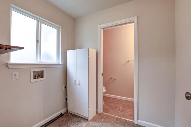 an empty room with windows and closet