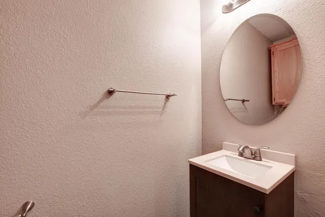 a bathroom with a sink and mirror